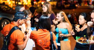 Tour group enjoying evening food and drinks at a night market in Siem Reap