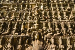 Terrace of the Leper King wall showing carved stone figures and deities in rows at Angkor