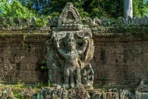 Large Garuda figure carved into the laterite outer wall of Prasat Preah Khan temple, Angkor