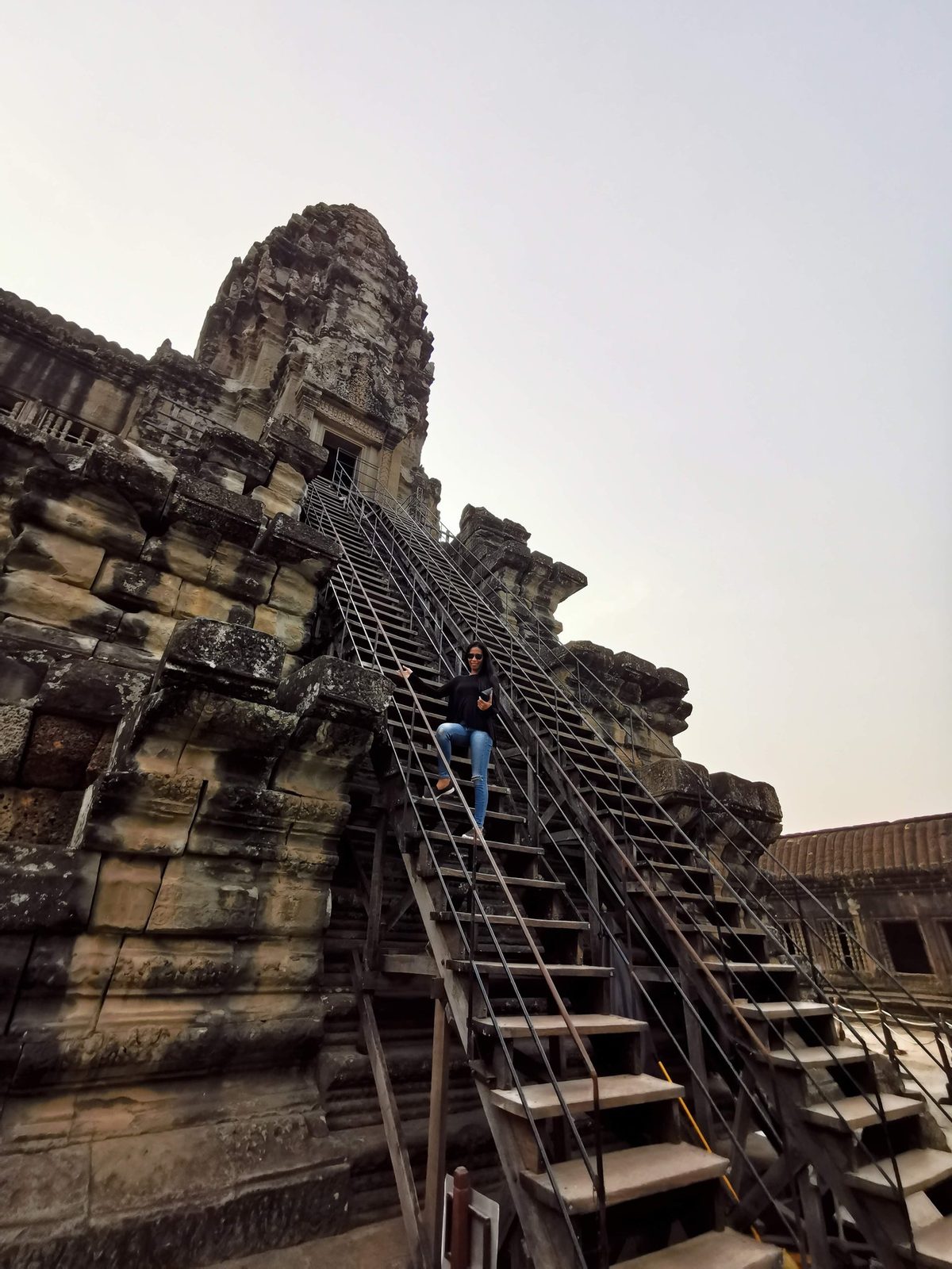 Steep wooden stairs to the Bakan upper tower at Angkor Wat, open to visitors aged 12 and above