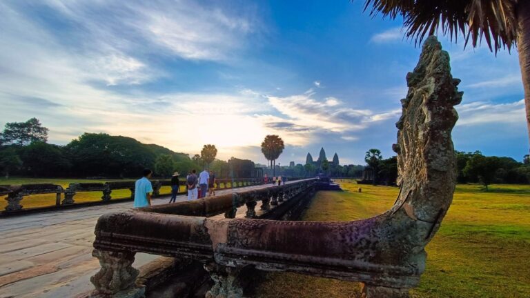 Carved naga balustrade on the Angkor Wat causeway in morning light.
