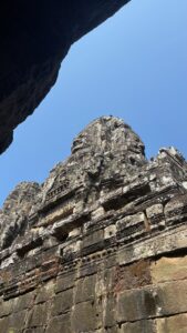 Bayon stone tower framed by a foreground archway.