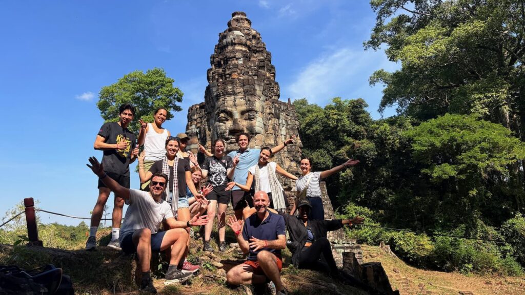 Adventures Cambodia guests at an Angkor Thom face tower, Siem Reap