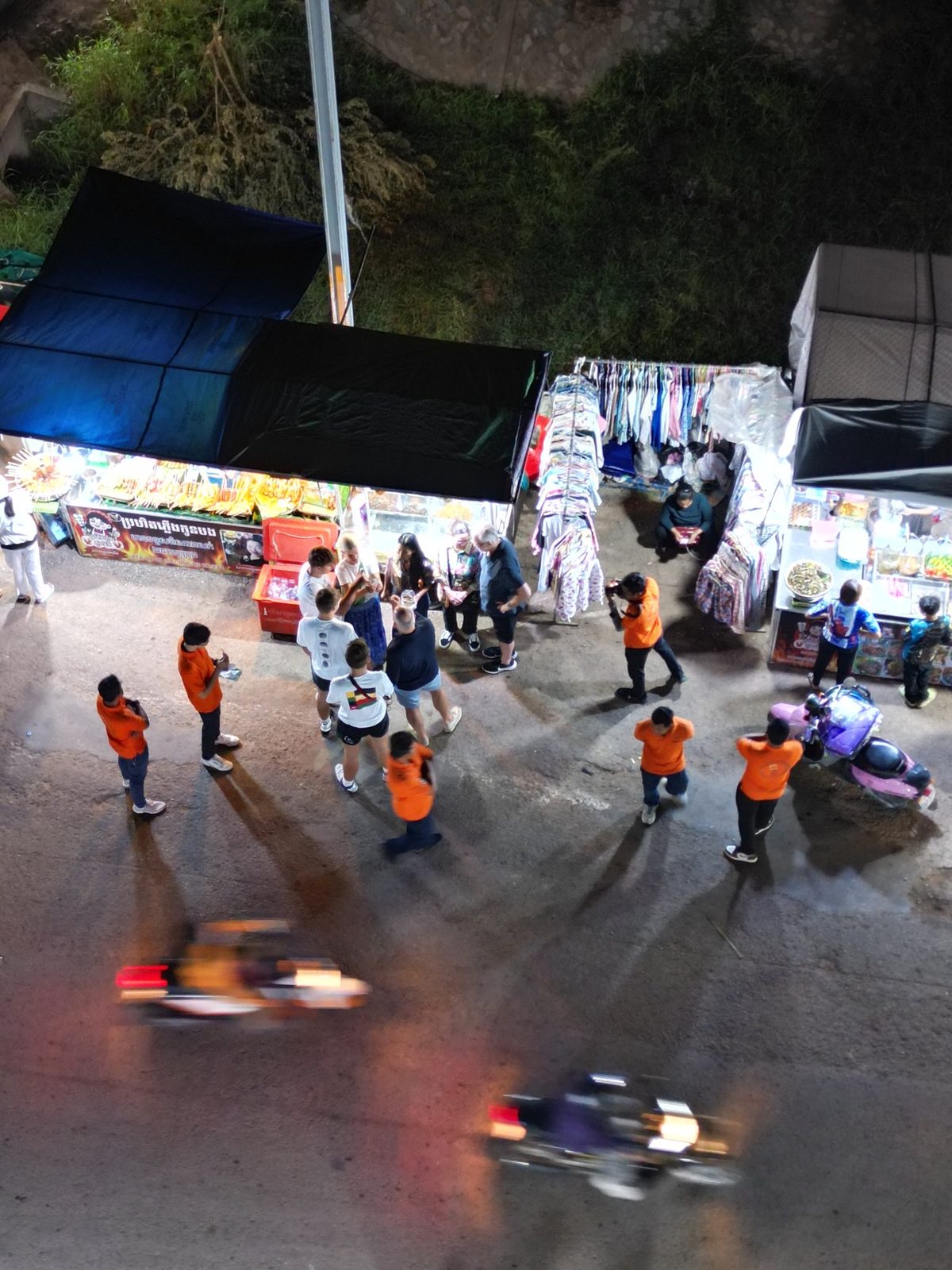 Overhead view of a busy Siem Reap night market with stalls and crowds