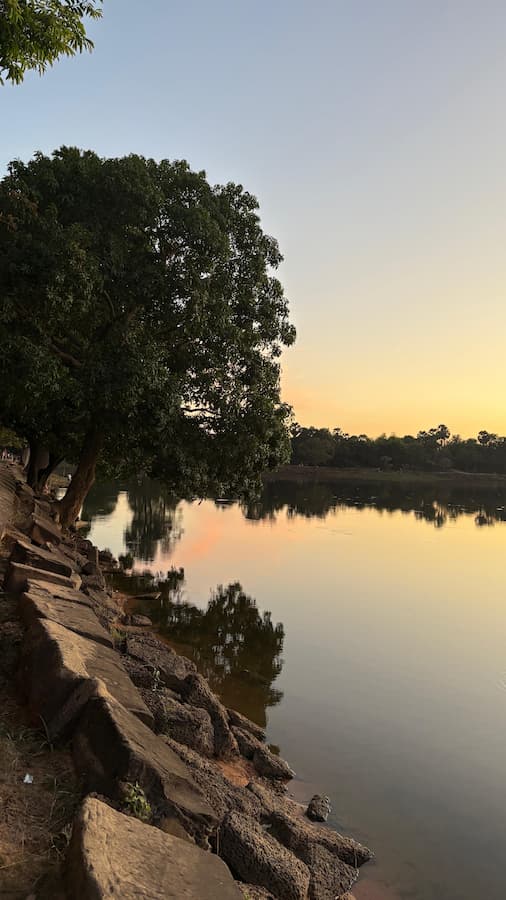 Srah Srang royal bath at sunset with laterite steps leading down to the still water