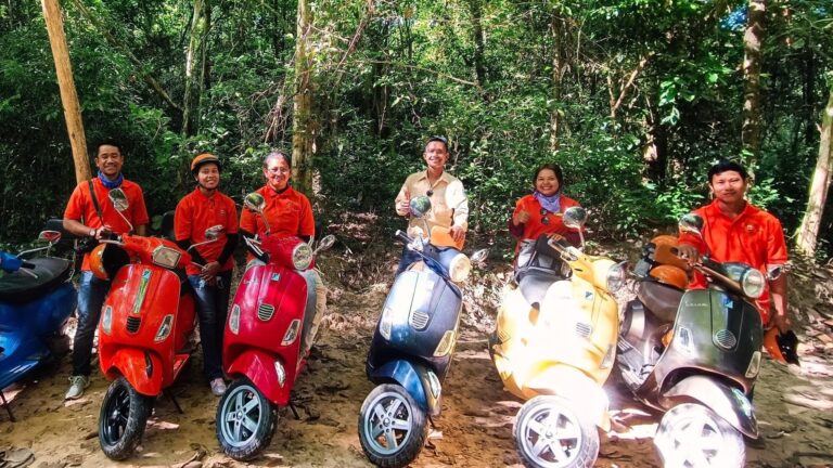 Adventures Cambodia Vespa group on a forest trail in the Angkor area.
