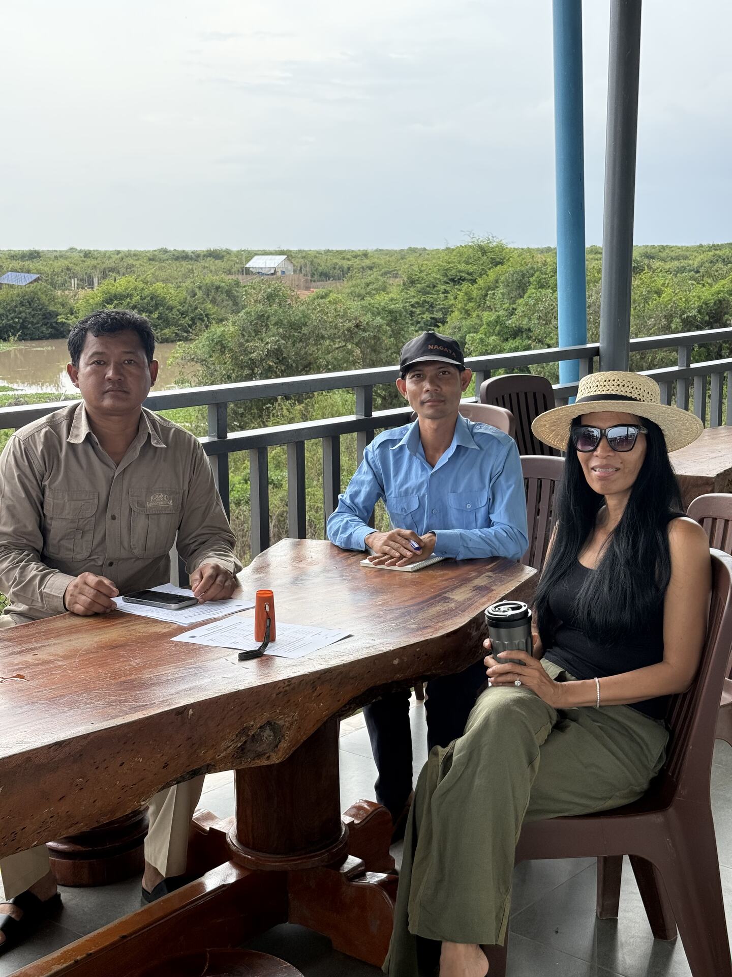 Akim Ly sitting down with members of the Kampong Phluk boat community