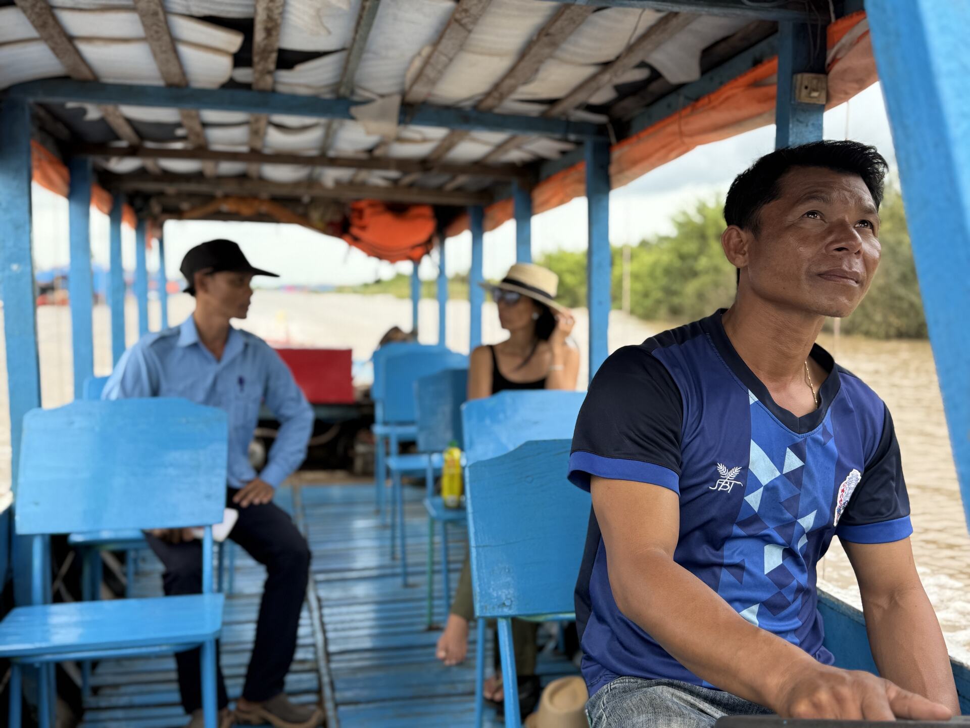 Adventures Cambodia guides on a wooden boat at the Kampong Phluk landing, Tonle Sap