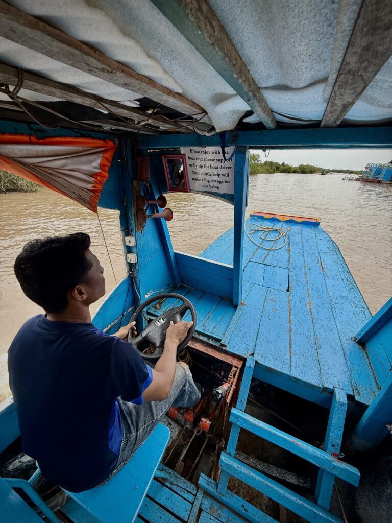 Guests and guides aboard a private covered boat at Kampong Phluk